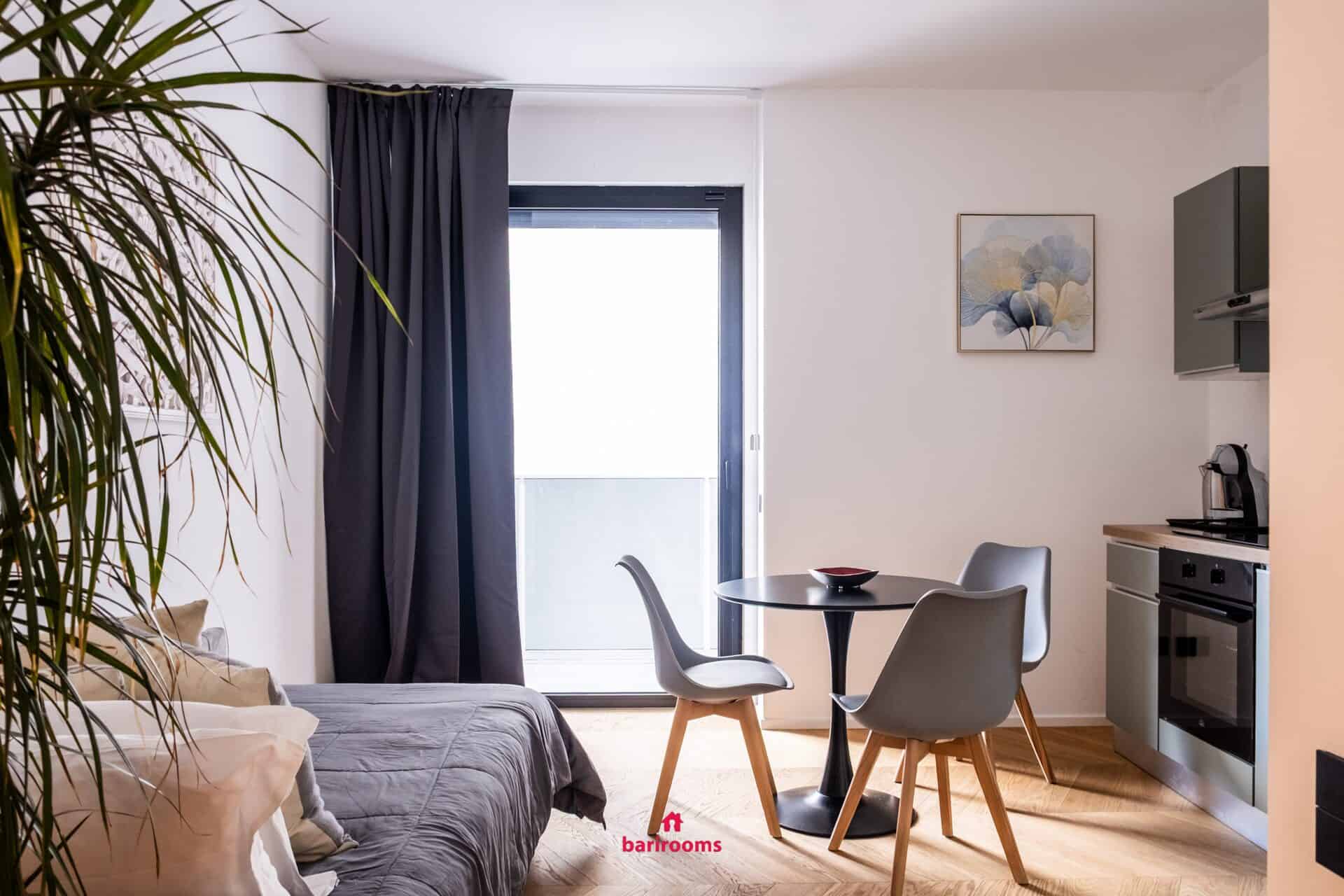 Soggiorno con divano letto e tavolo da pranzo, appartamento Metropole Bari